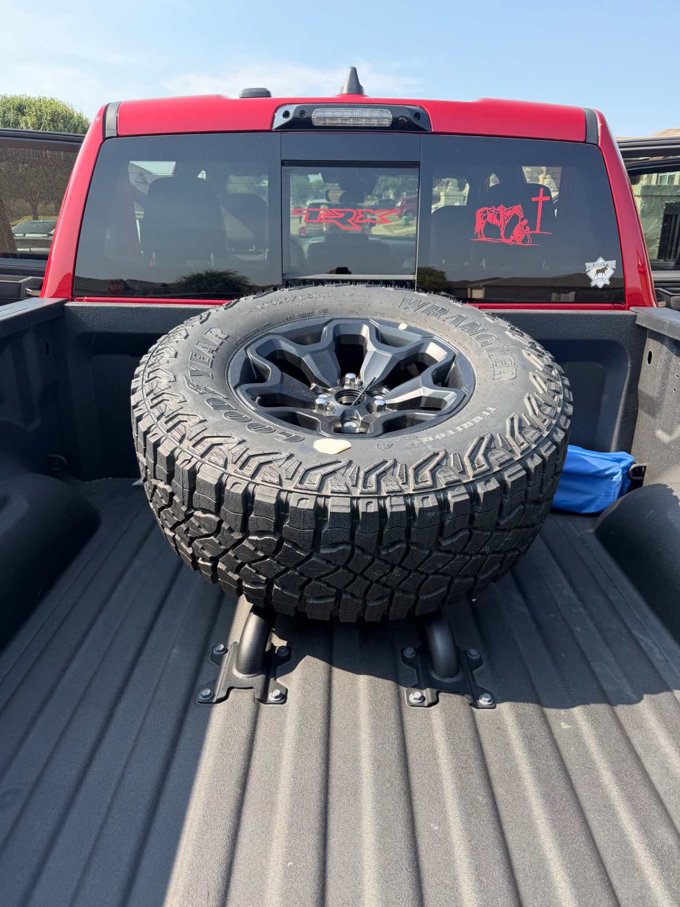 Full-size spare wheel mounted in the truck bed